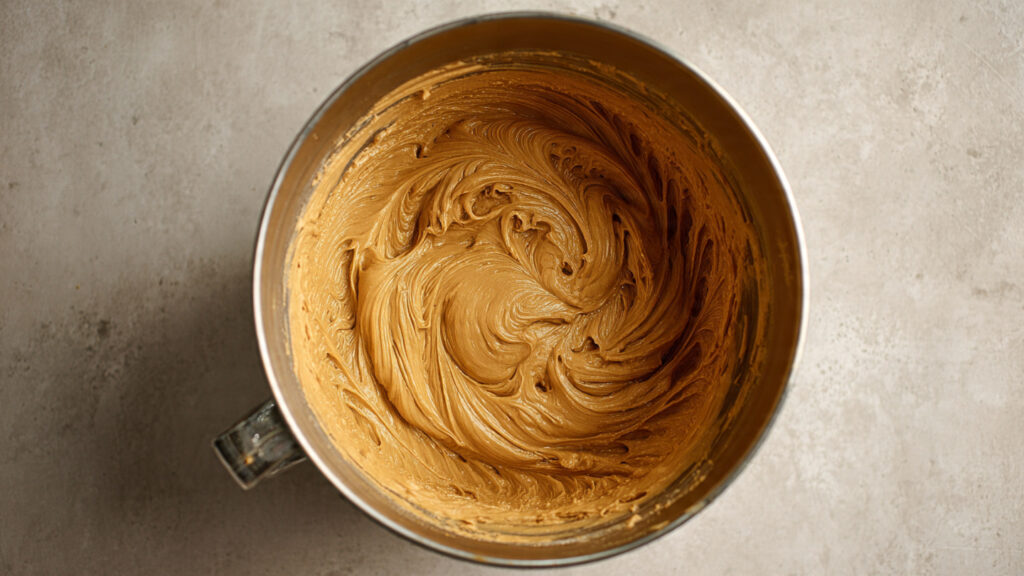 Quick & Creamy Speculoos Cinnamon Tiramisu 3 Whipped Speculoos cream in a metal mixing bowl for Speculoos Cinnamon Tiramisu